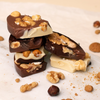 Stack of pieces of tree different types chocolate with nuts