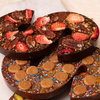 Stack of several delicious looking chocolate letters S with different toppings